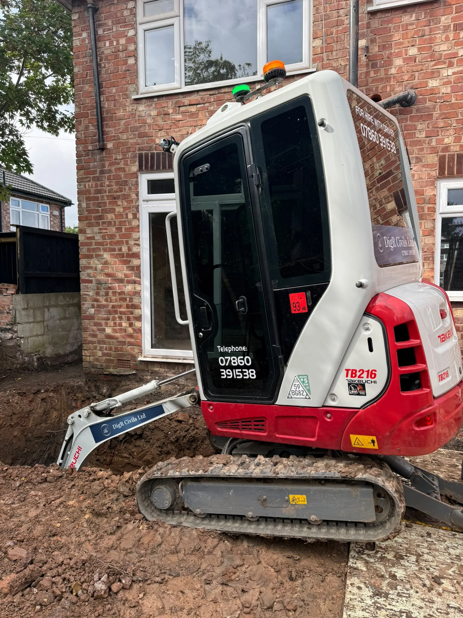 Machine working in a deep residential foundation dig