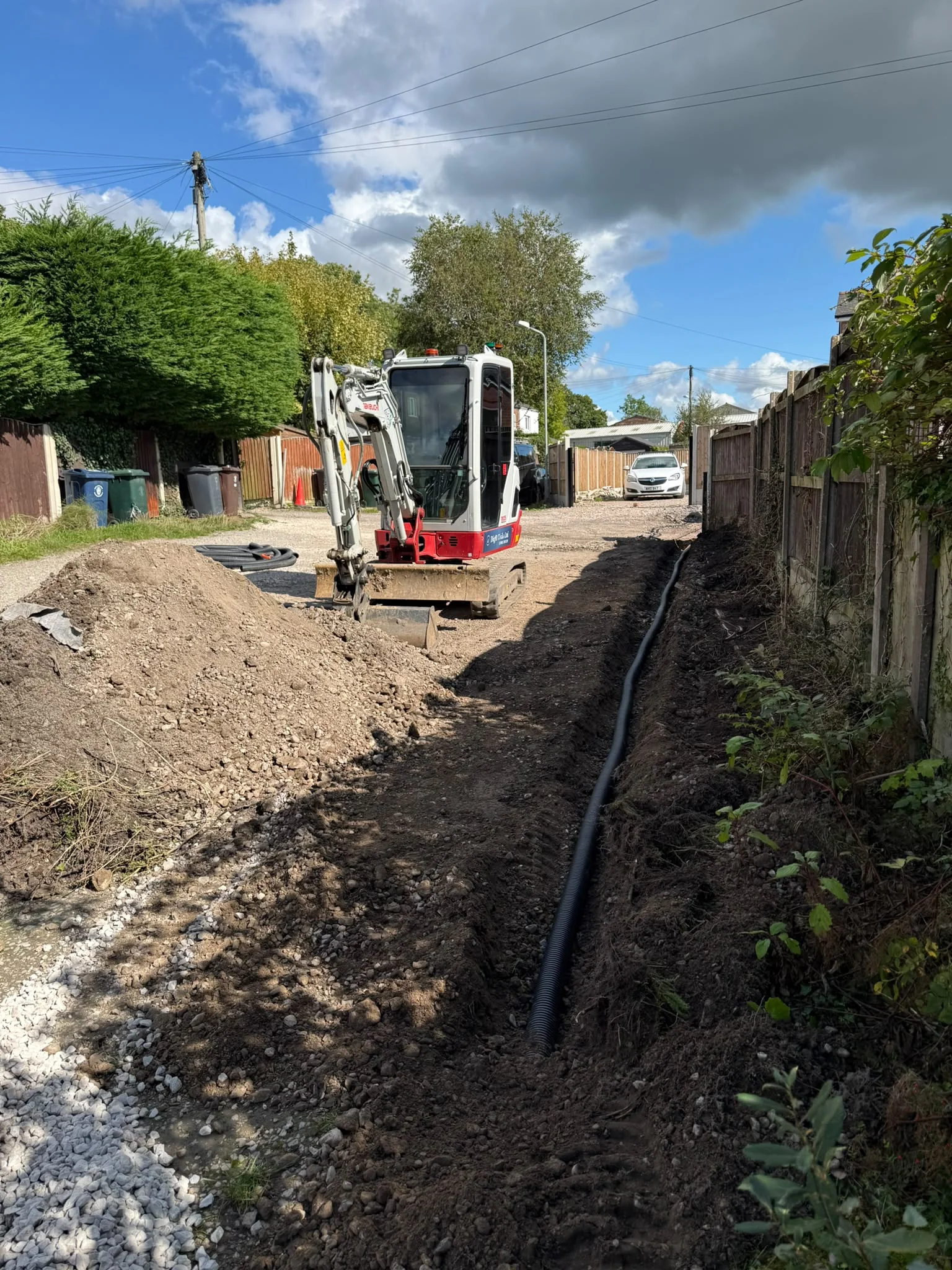 Drainage trench and pipe beside a residential property