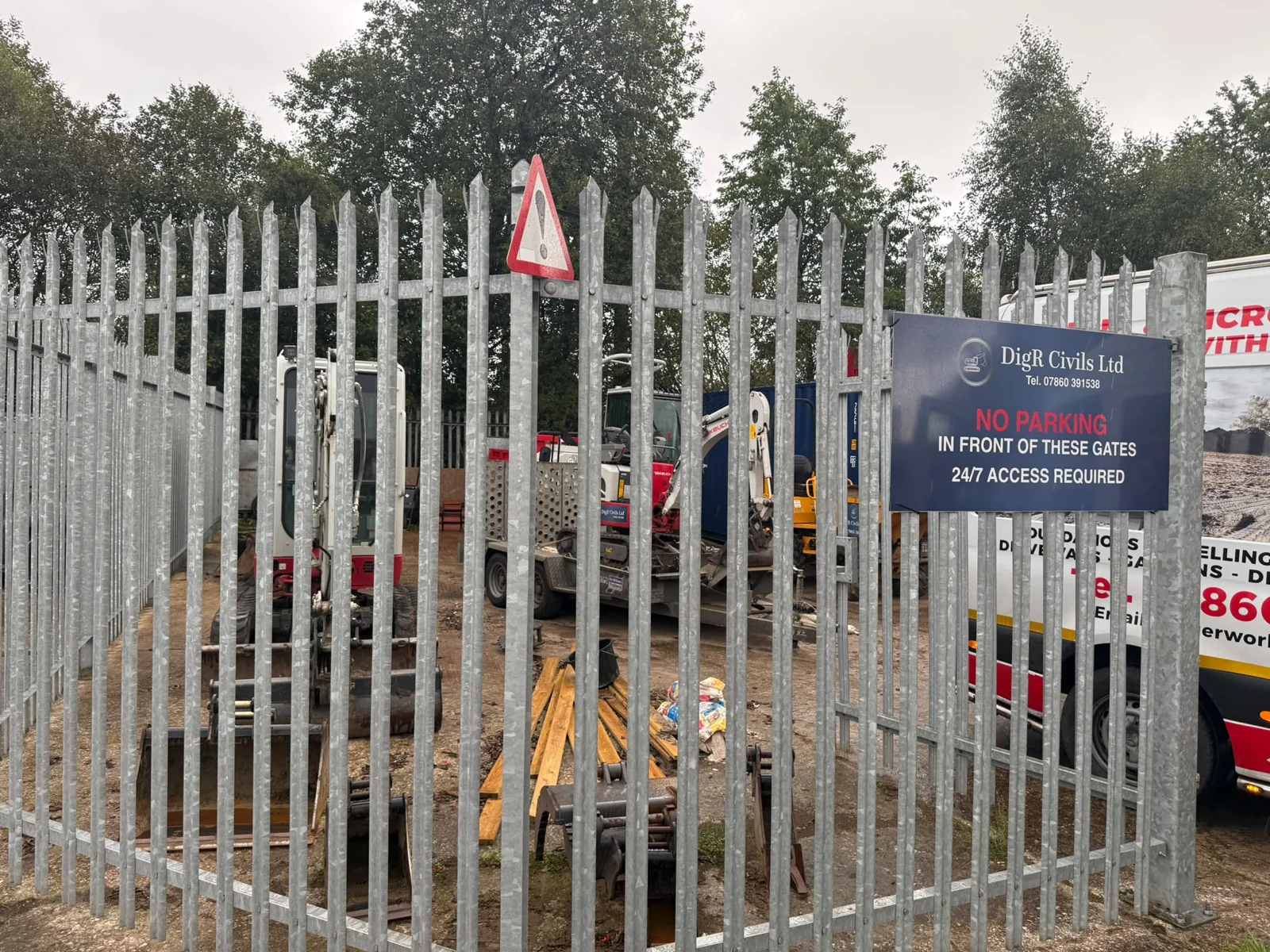 DigR Civils yard gates with branded sign and plant behind