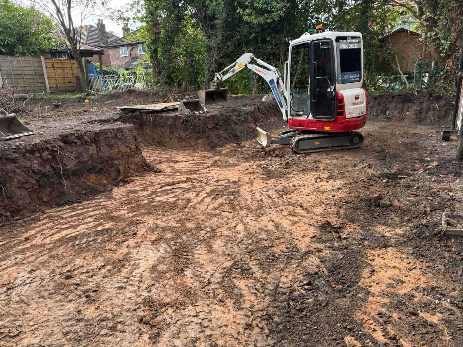 Mini digger on a newly excavated and levelled garden