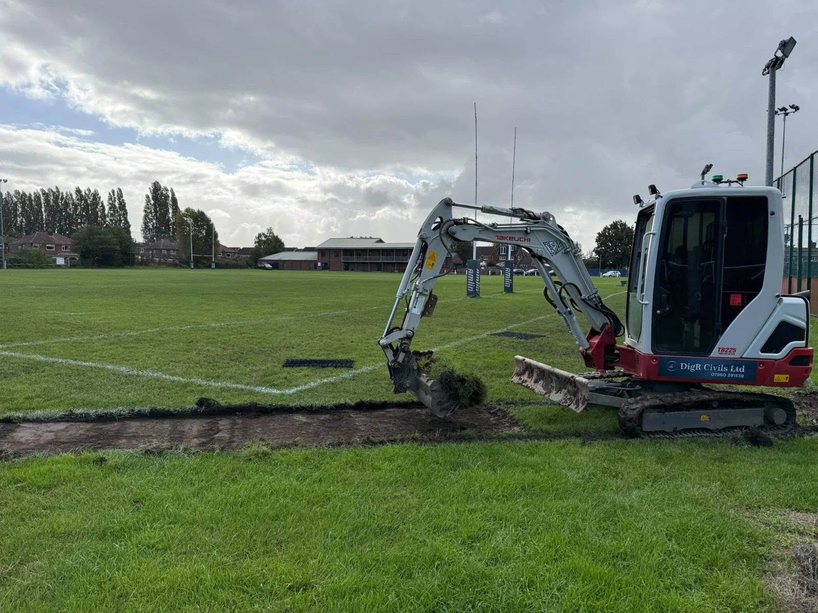 Excavator forming a track through an open area