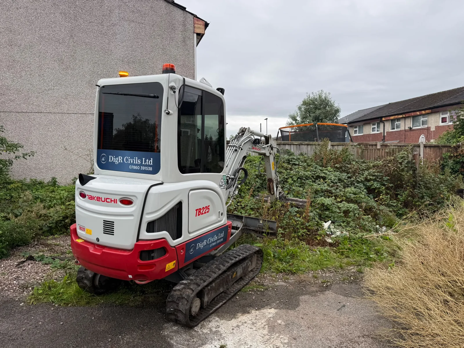 Excavator clearing an overgrown site